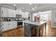 Modern kitchen with white cabinets, a gray island, and stainless steel appliances at 440 Luray Way, Rock Hill, SC 29730