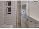 Bathroom featuring white subway tile, a bathtub, and built-in shelving at 4601 Coronado Dr # C, Charlotte, NC 28212