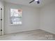 Bright bedroom with vinyl flooring and a view of the community pool at 4601 Coronado Dr # C, Charlotte, NC 28212