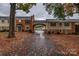 Brick front exterior with covered carport and autumn leaves at 4601 Coronado Dr # C, Charlotte, NC 28212