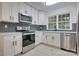 Updated kitchen boasts white cabinets, stainless steel appliances, and stylish backsplash at 4601 Coronado Dr # C, Charlotte, NC 28212