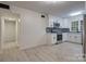 Modern kitchen with white cabinets, stainless steel appliances and view into hallway at 4601 Coronado Dr # C, Charlotte, NC 28212