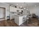 Well-equipped kitchen with white cabinets, granite countertops, and island seating at 6235 Scuttle Ln, Denver, NC 28037