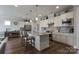 Modern kitchen with white cabinets, granite island, and stainless steel appliances at 6235 Scuttle Ln, Denver, NC 28037