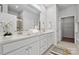 Bathroom with double sink vanity, white cabinets, framed mirror, and walk-in shower at 885 Exeter Dr, Sherrills Ford, NC 28673