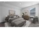 Cozy bedroom featuring neutral colors, plush textures, and a large sunny window at 885 Exeter Dr, Sherrills Ford, NC 28673