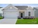 Charming single-story home with a two-car garage, black front door, and a well-manicured lawn at 885 Exeter Dr, Sherrills Ford, NC 28673