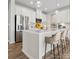 Modern kitchen with a spacious island and barstool seating, stainless steel appliances, and contemporary lighting at 885 Exeter Dr, Sherrills Ford, NC 28673