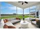 A bright screened porch featuring a ceiling fan, outdoor seating, and expansive green views at 885 Exeter Dr, Sherrills Ford, NC 28673