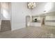 Open living room and kitchen with high ceilings and hardwood floors at 11918 Fox Glen Rd, Charlotte, NC 28269