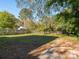 Large backyard with mature trees, grassy area, and partial fence, offering privacy and outdoor space at 1411 Lineberger Ave, Gastonia, NC 28052