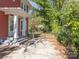 A view of the backyard featuring a brick home with white columns, and a gated driveway leading to the back at 1411 Lineberger Ave, Gastonia, NC 28052