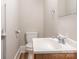 A light and airy bathroom with updated sink, toilet, and flooring offers a comfortable, clean aesthetic at 1411 Lineberger Ave, Gastonia, NC 28052