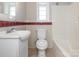 This bathroom features an updated sink, and combination tub and shower with white fixtures at 1411 Lineberger Ave, Gastonia, NC 28052