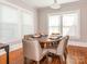 Inviting dining room featuring hardwood floors, neutral paint, and large windows at 1411 Lineberger Ave, Gastonia, NC 28052