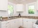 Bright kitchen featuring white cabinetry, a stainless steel sink, and ample counter space at 1411 Lineberger Ave, Gastonia, NC 28052