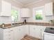 Efficient kitchen with white cabinets, bright light, and linoleum floors at 1411 Lineberger Ave, Gastonia, NC 28052