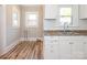View of the pantry area featuring built in cabinets and laminate flooring at 1411 Lineberger Ave, Gastonia, NC 28052