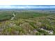 Expansive aerial view showcases the property surrounded by trees, offering privacy and a serene setting at 2164 Mission Rd, York, SC 29745