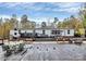 Large backyard deck for outdoor entertaining, featuring ample seating and views of mature trees at 2164 Mission Rd, York, SC 29745