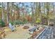 Backyard featuring firepit and seating in wooded landscape at 2164 Mission Rd, York, SC 29745