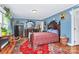 Tranquil bedroom with red floral bedding, warm wood accents, and charming decor at 2164 Mission Rd, York, SC 29745