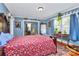 Comfortable bedroom with a red floral bedding, a decorative mirror, and ample natural light at 2164 Mission Rd, York, SC 29745