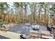 Large deck featuring multiple seating areas and a tranquil view of the surrounding woods at 2164 Mission Rd, York, SC 29745
