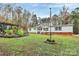 Inviting single-story home with green lawn, mature trees, colorful garden beds, and a patriotic American flag at 2164 Mission Rd, York, SC 29745