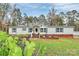 Charming single-story home featuring a manicured lawn, stylish shutters, and front porch decorations for a cozy curb appeal at 2164 Mission Rd, York, SC 29745