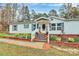 Charming single-story home with well-manicured landscaping and a welcoming front porch decorated for fall at 2164 Mission Rd, York, SC 29745