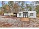 Exterior of a modern shed with a wooden ramp surrounded by wooded landscape at 2164 Mission Rd, York, SC 29745