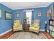 Inviting sitting area features two armchairs, a side table, and natural light, creating a cozy and comfortable space at 2164 Mission Rd, York, SC 29745