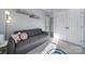 Bedroom with a gray sofa and built in shelving at 4330 Park South Station Blvd, Charlotte, NC 28210