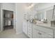 Elegant bathroom featuring a double sink vanity, stylish mirrors, and a walk-in closet at 8364 Acadia Pkwy, Sherrills Ford, NC 28673