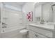 This is a bright bathroom with tub-shower combo, white vanity, and a framed mirror at 8364 Acadia Pkwy, Sherrills Ford, NC 28673