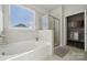 Bright bathroom features a soaking tub, a glass-enclosed shower and a walk-in closet at 8364 Acadia Pkwy, Sherrills Ford, NC 28673