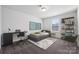 Well-lit bedroom with a workspace, neutral tones, and a comfortable bed at 8364 Acadia Pkwy, Sherrills Ford, NC 28673
