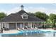 Exterior view of a community pool and clubhouse with lounge chairs and manicured landscaping at 8364 Acadia Pkwy, Sherrills Ford, NC 28673