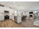 Open-concept kitchen and living room with hardwood floors, stainless steel appliances, and modern fixtures at 8364 Acadia Pkwy, Sherrills Ford, NC 28673