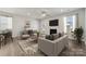 Bright living room with a cozy fireplace, modern furnishings, and seamless flow to the outdoors at 8364 Acadia Pkwy, Sherrills Ford, NC 28673