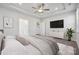 This is a luxurious bedroom with a tray ceiling, large TV, neutral tones and stylish furniture at 8364 Acadia Pkwy, Sherrills Ford, NC 28673