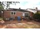 Back exterior of house with brick and neutral siding with trees and utilities at 206 Swaim Ct, Salisbury, NC 28147