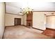 Open living room featuring a brick fireplace, traditional chandelier and ceiling fan at 206 Swaim Ct, Salisbury, NC 28147