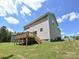 Exterior view of home's backyard featuring a wooden deck, stairs, and lawn at 2387 Trundle Dr # Cwo0155, Gastonia, NC 28054