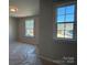 Bright bedroom featuring two large windows, neutral walls, and new carpet at 2387 Trundle Dr # Cwo0155, Gastonia, NC 28054