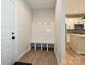 Bright entryway featuring a built-in bench with coat hooks next to a kitchen with white cabinets at 2387 Trundle Dr # Cwo0155, Gastonia, NC 28054