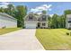 Two-story house with a wide driveway, green lawn, and gray siding, under a bright blue sky at 2387 Trundle Dr # Cwo0155, Gastonia, NC 28054