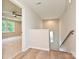 Upstairs hallway with wood flooring leading to a carpeted bedroom with a tray ceiling and large window at 2387 Trundle Dr # Cwo0155, Gastonia, NC 28054