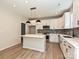 Modern kitchen with white cabinets, kitchen island, tiled backsplash, and modern lighting at 2387 Trundle Dr # Cwo0155, Gastonia, NC 28054